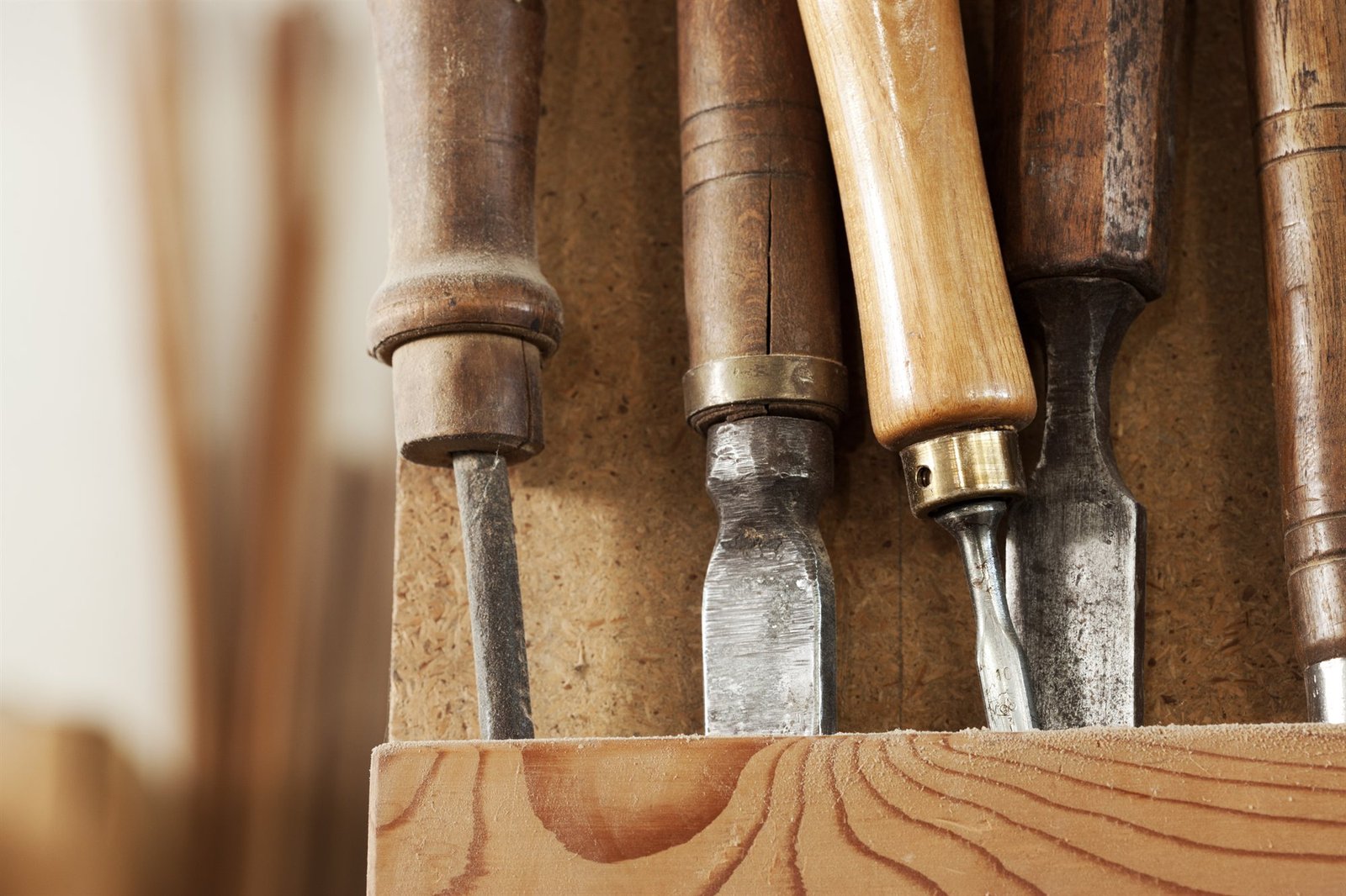 Authentic wooden-handled chisels and timber carving tools in workshop